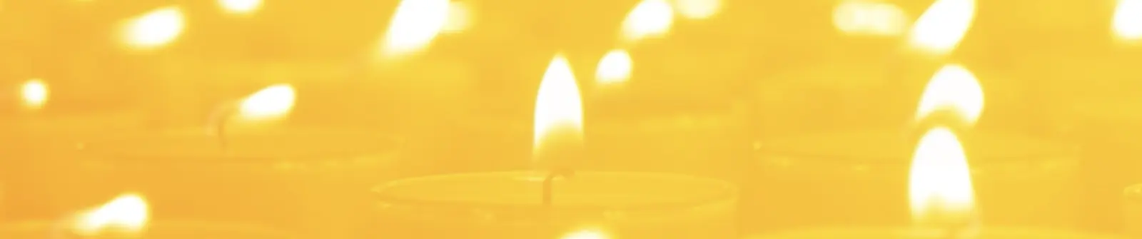 A sea of lit candles, each one for a remembered life